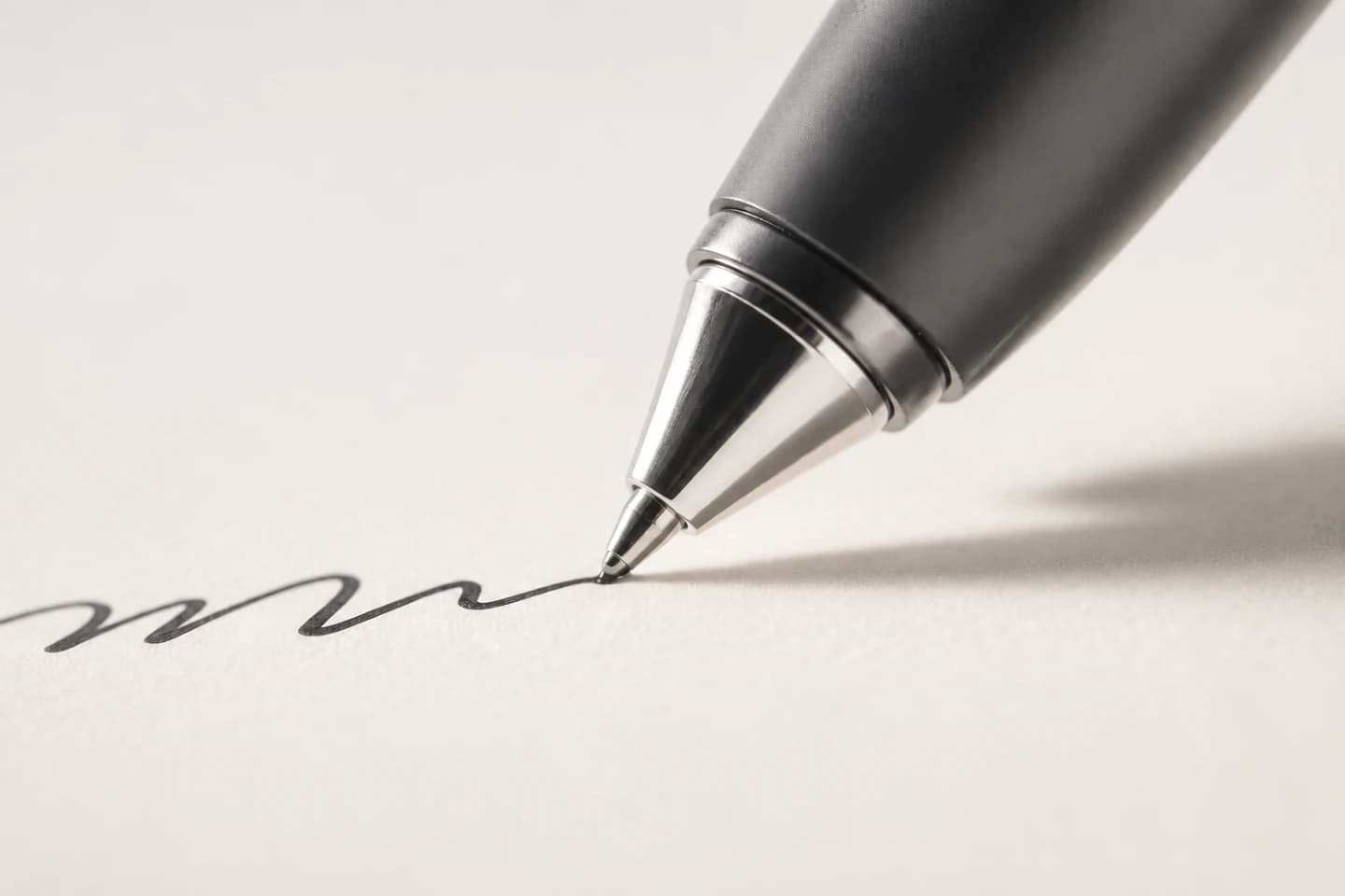 Extreme close-up of a smart AI pen tip writing on paper under warm amber light